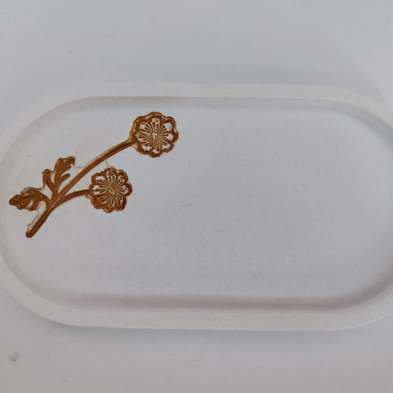 Bandeja ovalada con varios diseños de flor dos pétalos, fabricado artesanalmente con cemento. (cada bandeja)